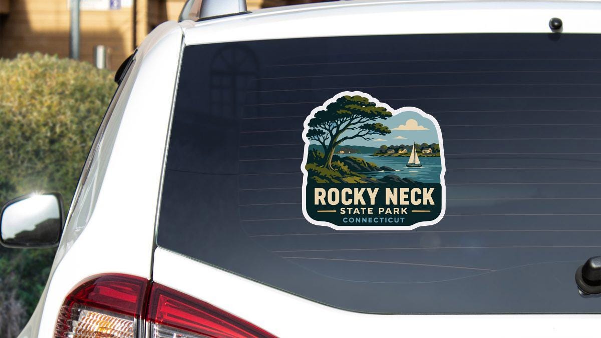 A sticker on the rear window of a white car, depicting a scenic landscape with a sailboat and a tree, indicating Rocky Neck State Park in Connecticut.