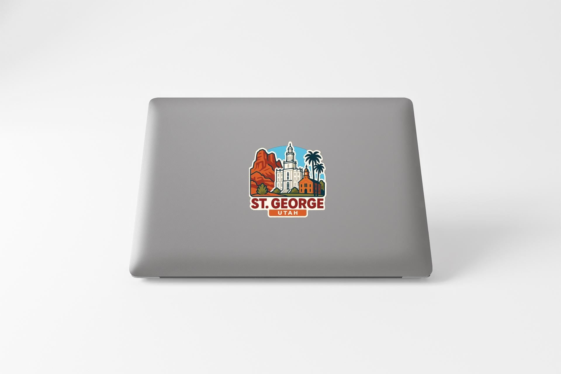 a sticker with a graphic of St. George, Utah, on the back of a laptop.