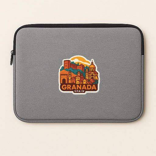 A gray laptop sleeve with a colorful graphic of Granada, Spain, featuring a cityscape with buildings, domes, and a sun.