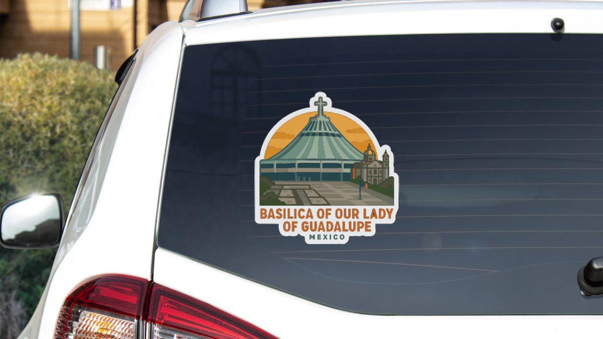 A sticker on the rear window of a white car, depicting the Basilica of Our Lady of Guadalupe in Mexico.