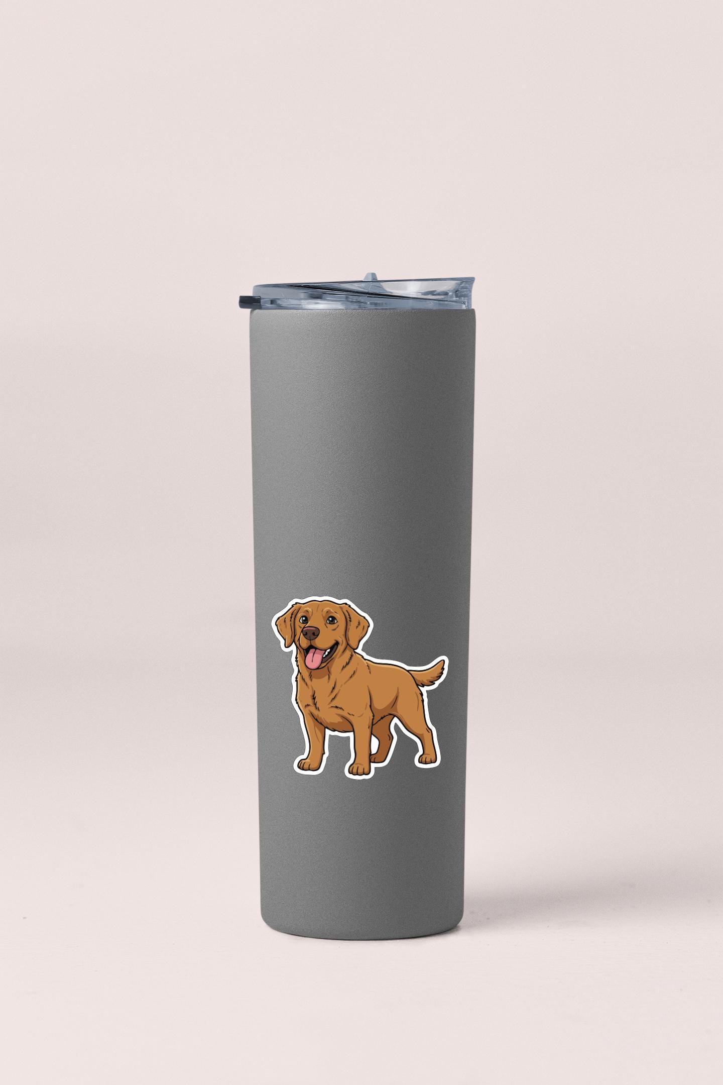 A gray insulated tumbler with a sticker of a brown dog on it.