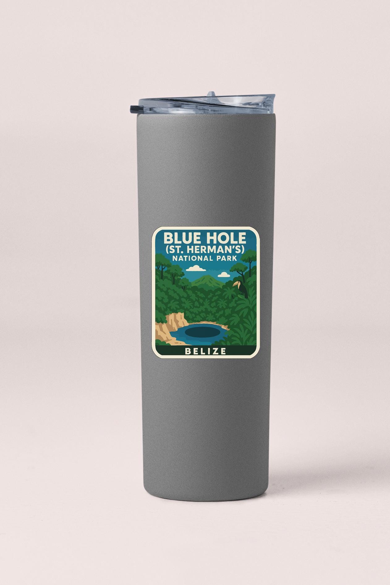 A gray insulated tumbler with a label that reads "BLUE HOLE (ST. HERMAN'S) NATIONAL PARK" and "BELIZE".