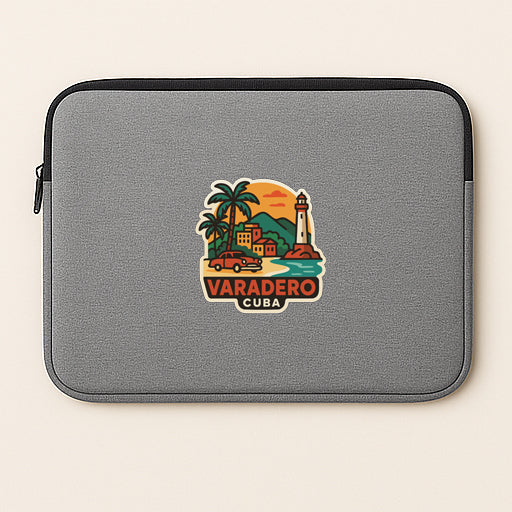 A gray laptop sleeve with a colorful graphic of Varadero, Cuba, featuring a lighthouse, palm trees, and a sunset.