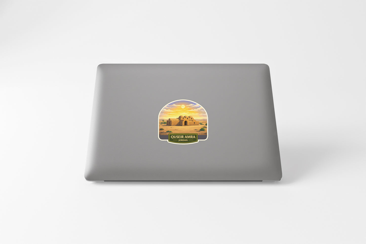A sticker depicting a desert landscape with a castle or fortification in the background.