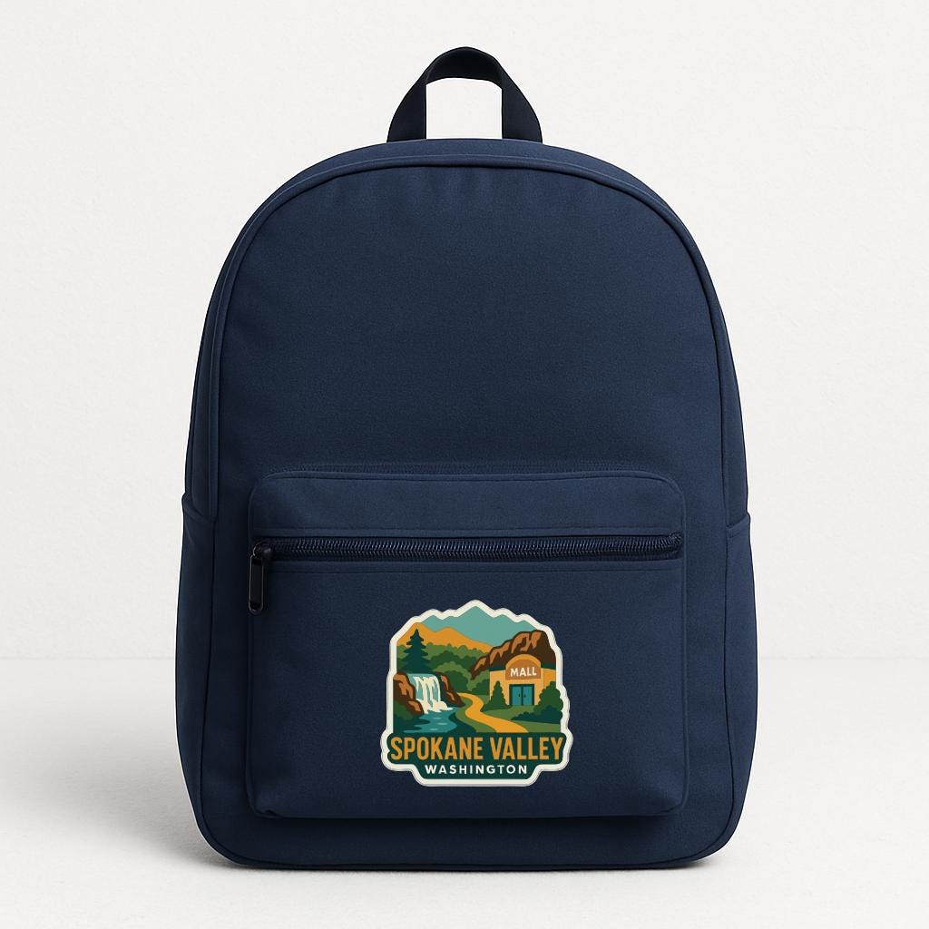 A navy blue backpack with a sticker on the front that says "SPOKANE VALLEY WASHINGTON".