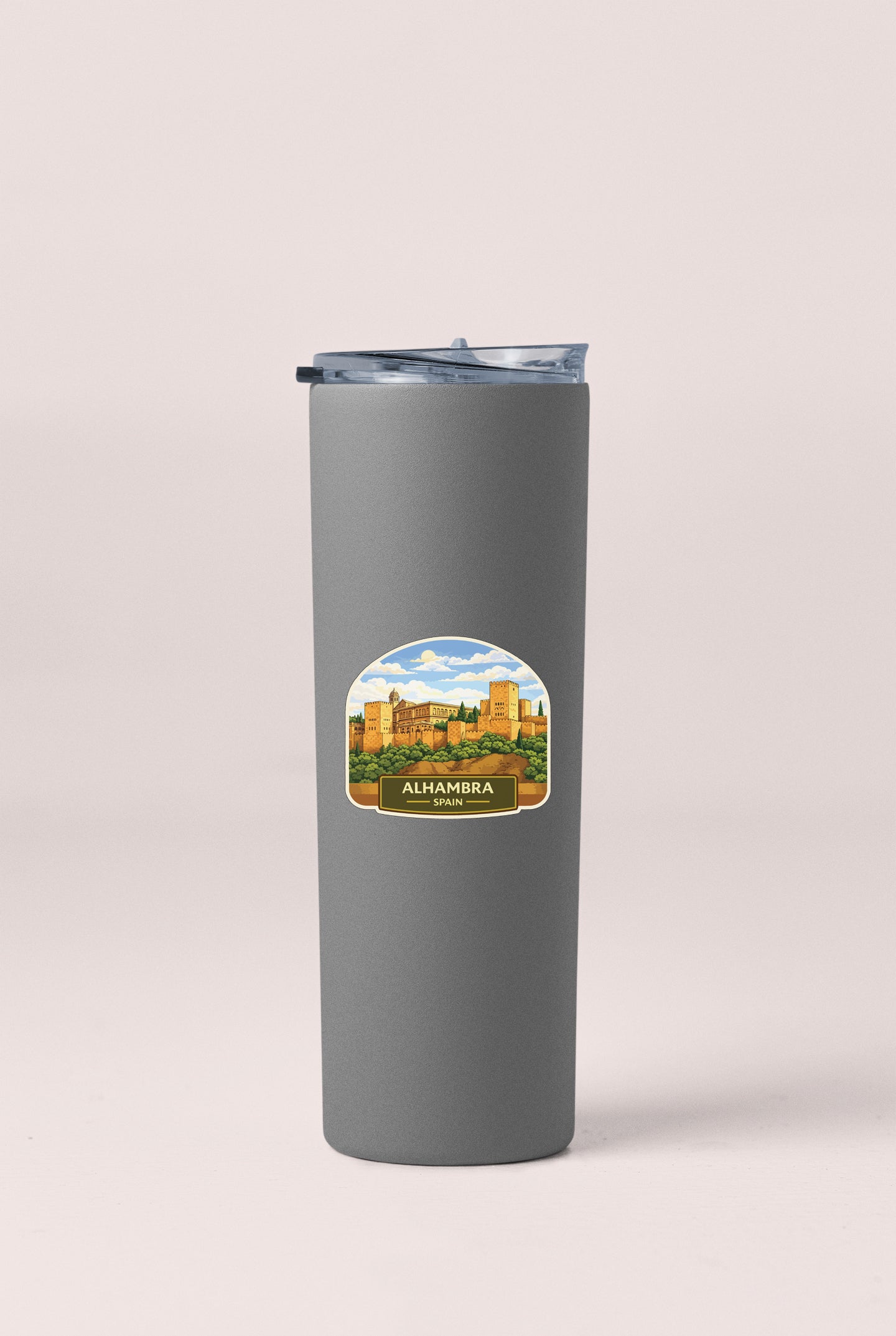 A gray insulated tumbler with a label that features an illustration of a cityscape and the text "ALHAMBRA SPRIN".