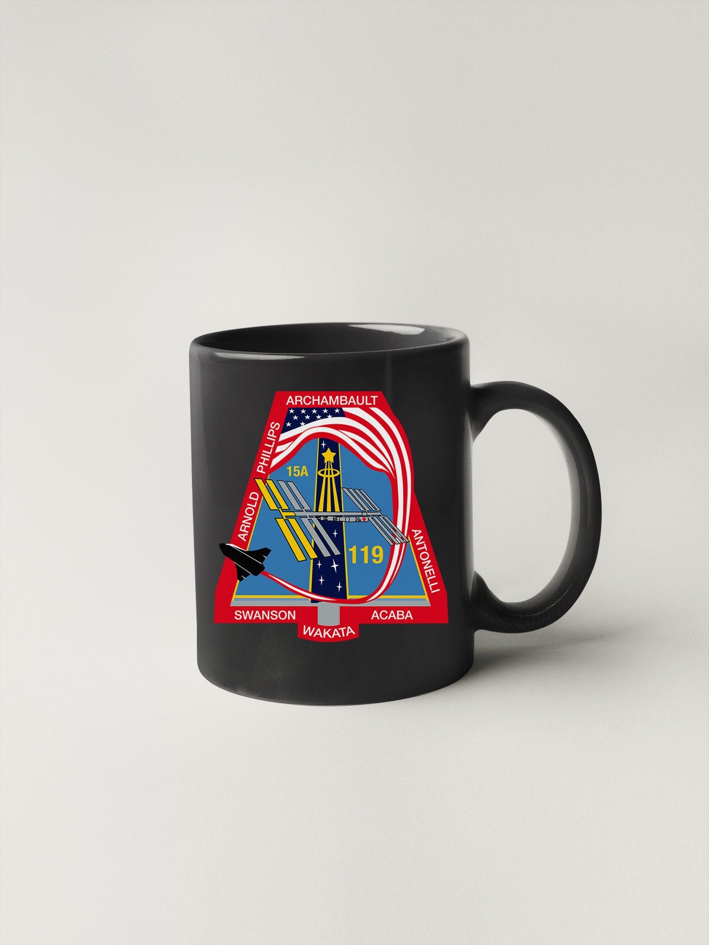 a black coffee mug with a picture of a woman holding a gun