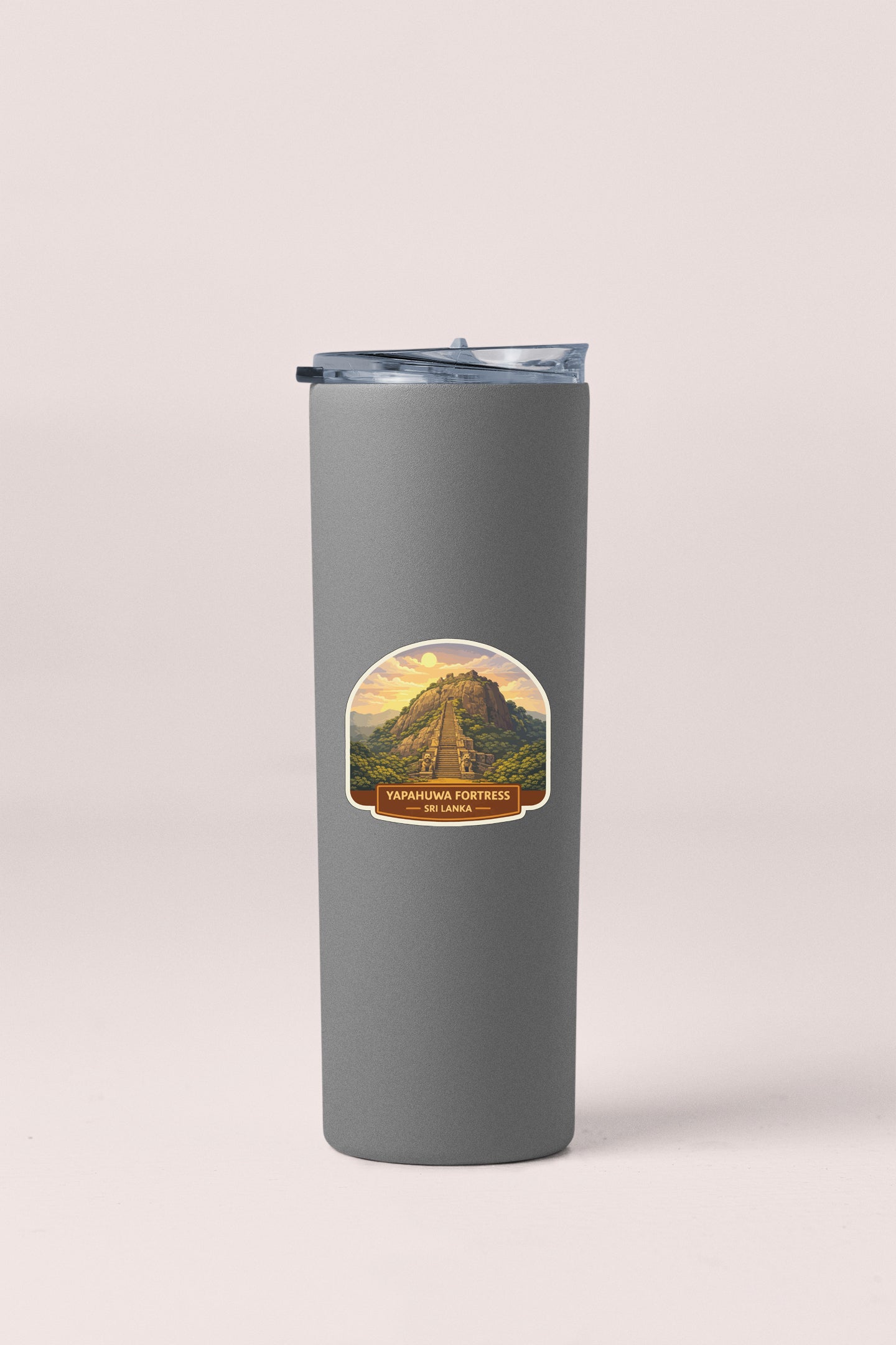 A gray insulated tumbler with a label depicting a mountain landscape.