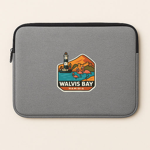 A gray laptop sleeve with a graphic design depicting a lighthouse, flamingos, and the text "WALVIS BAY NAMIBIA".