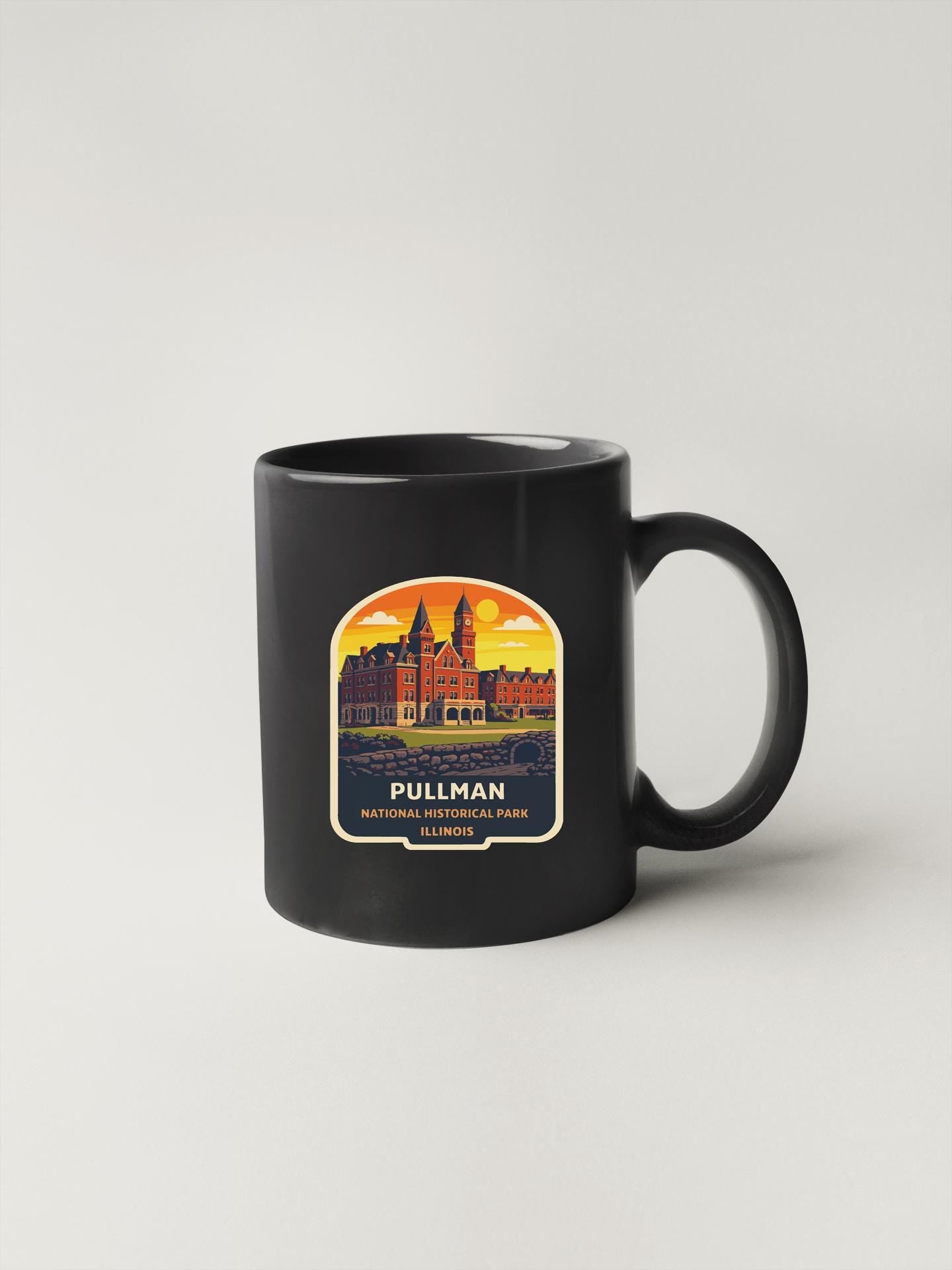 A black coffee mug with a graphic design depicting a castle or historical building, along with the text "PULLMAN NATIONAL HISTORICAL PARK IL".