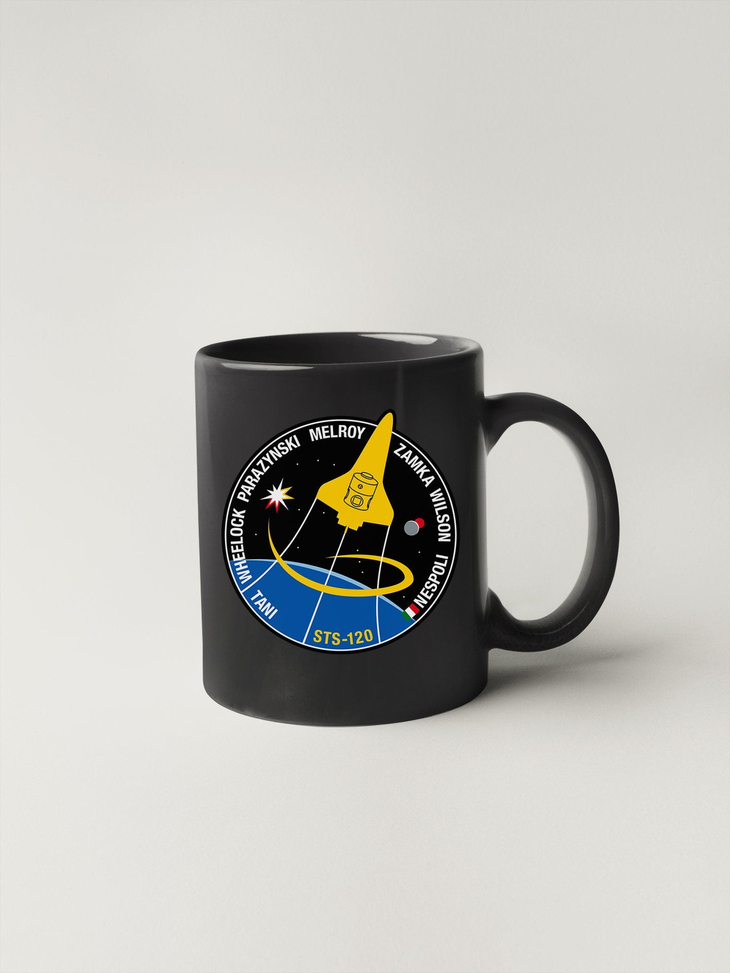 a black mug with a nasa emblem on it