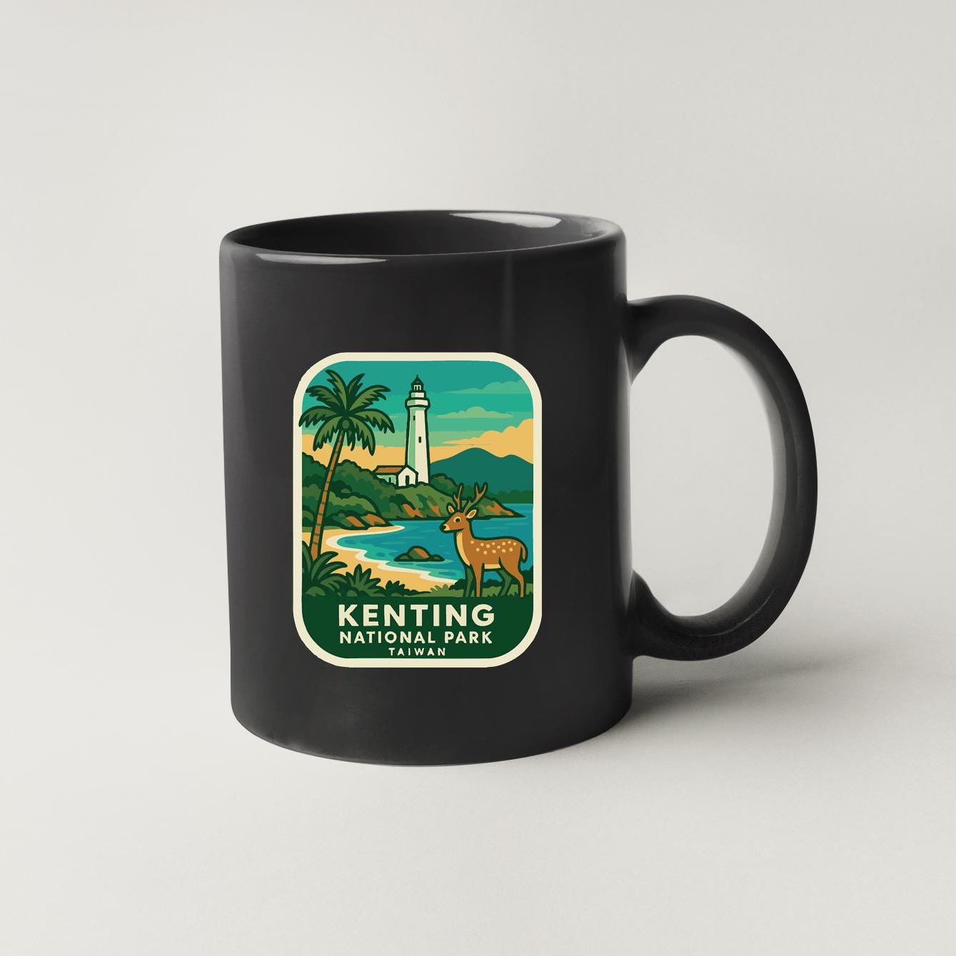 A black coffee mug with a graphic design depicting a lighthouse, palm trees, and a deer in the Kenting National Park, Taiwan.