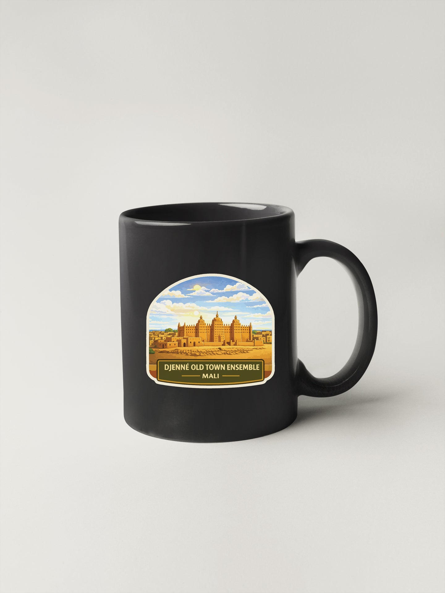 A black coffee mug with a label that says "Dienne Old Town ensemble MALI".