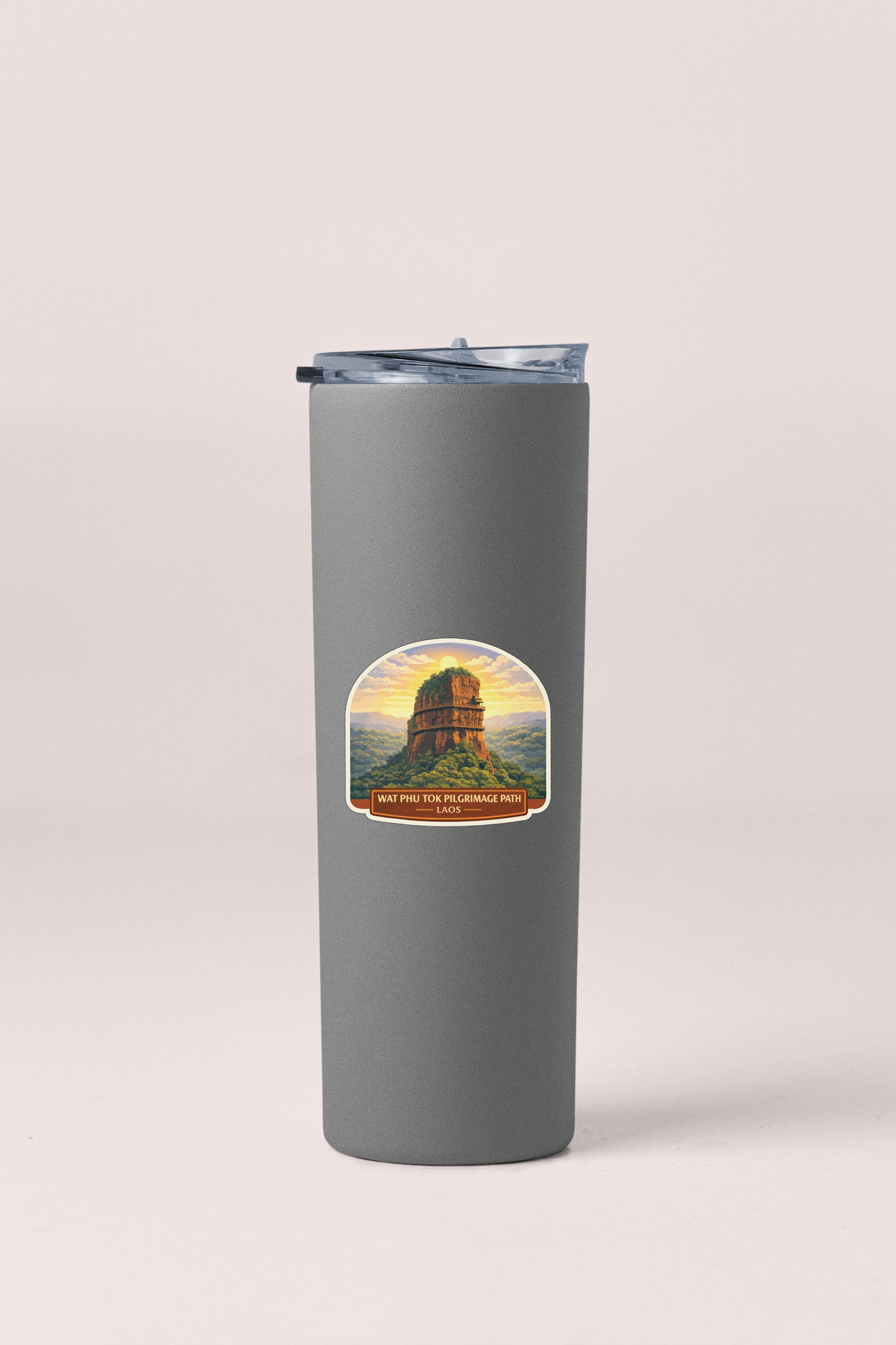 A gray insulated tumbler with a sticker depicting a mountain landscape.