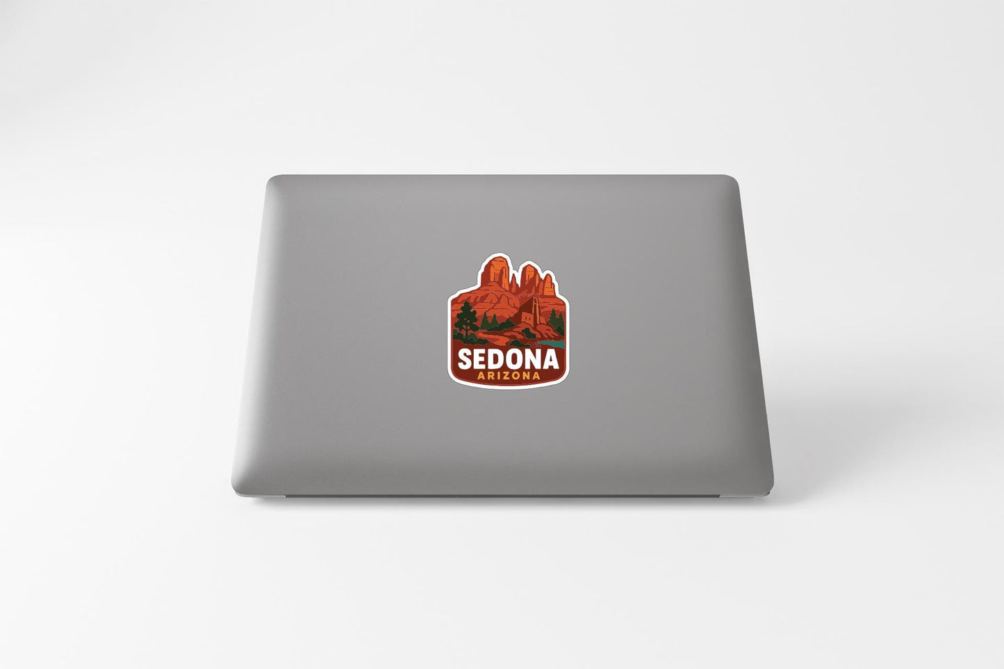 a sticker with the text "SEDONA ARIZONA" on the back of a laptop.