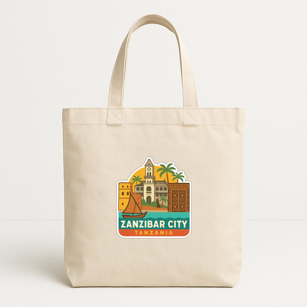 A beige tote bag with a printed design depicting landmarks and buildings of Zanzibar City, Tanzania.
