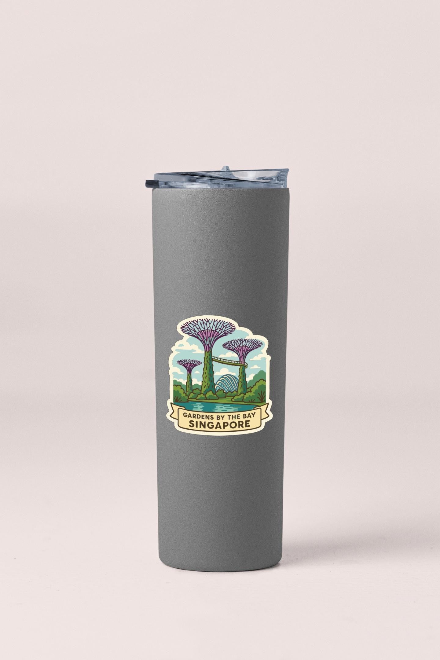 A gray insulated tumbler with a sticker depicting the Gardens by the Bay in Singapore.