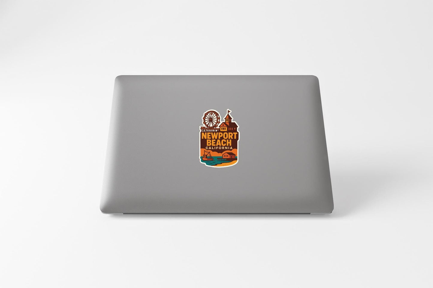 a sticker on the back of a laptop that says "Newport Beach California".