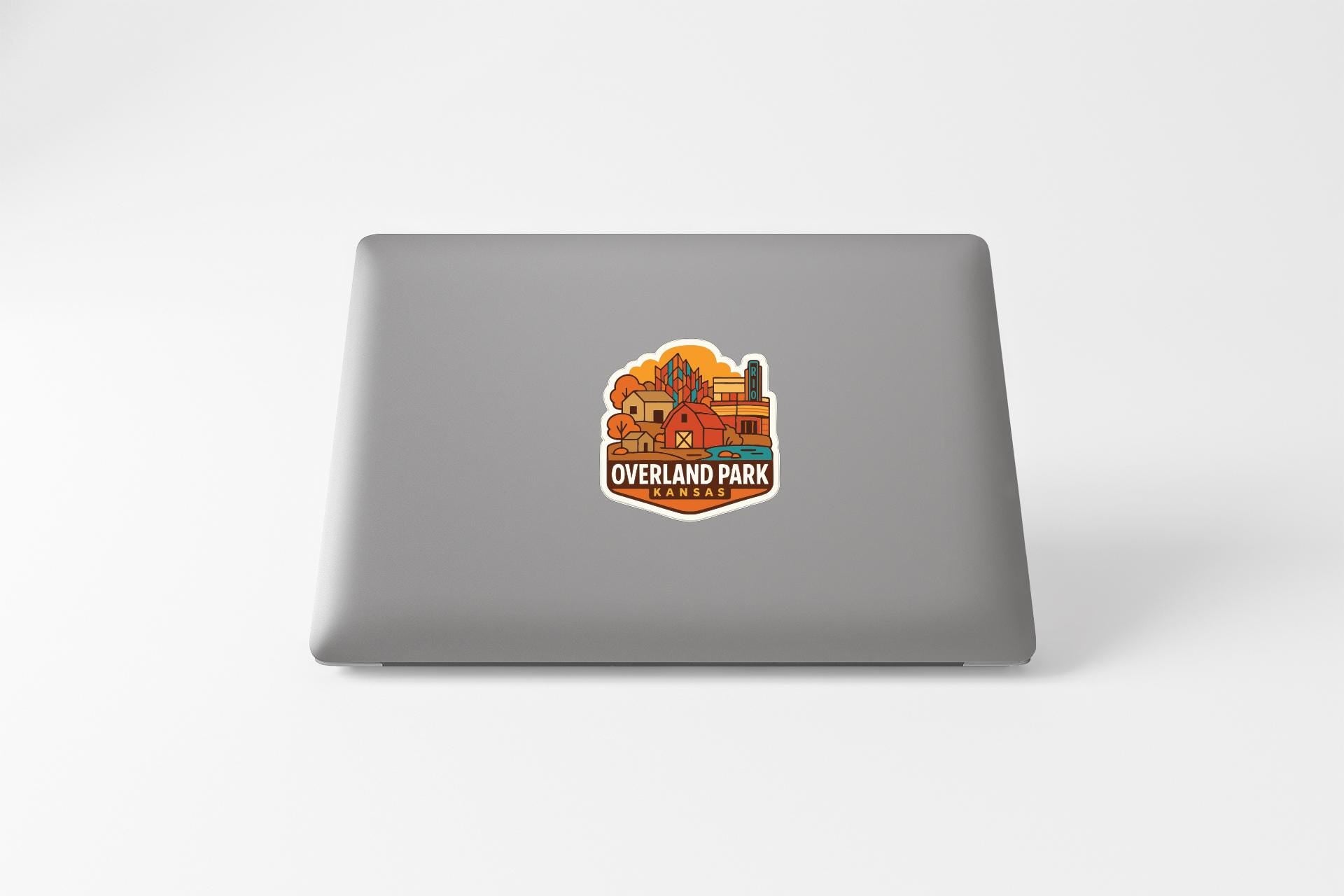a sticker on the back of a laptop that says "Overland Park".
