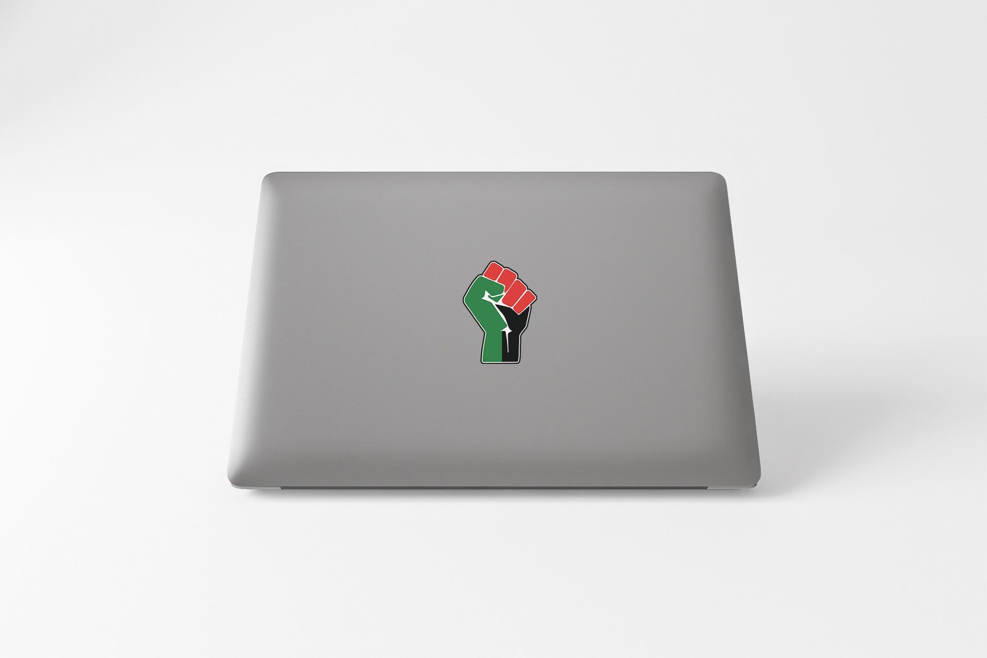 a laptop with a sticker of a hand holding a flag