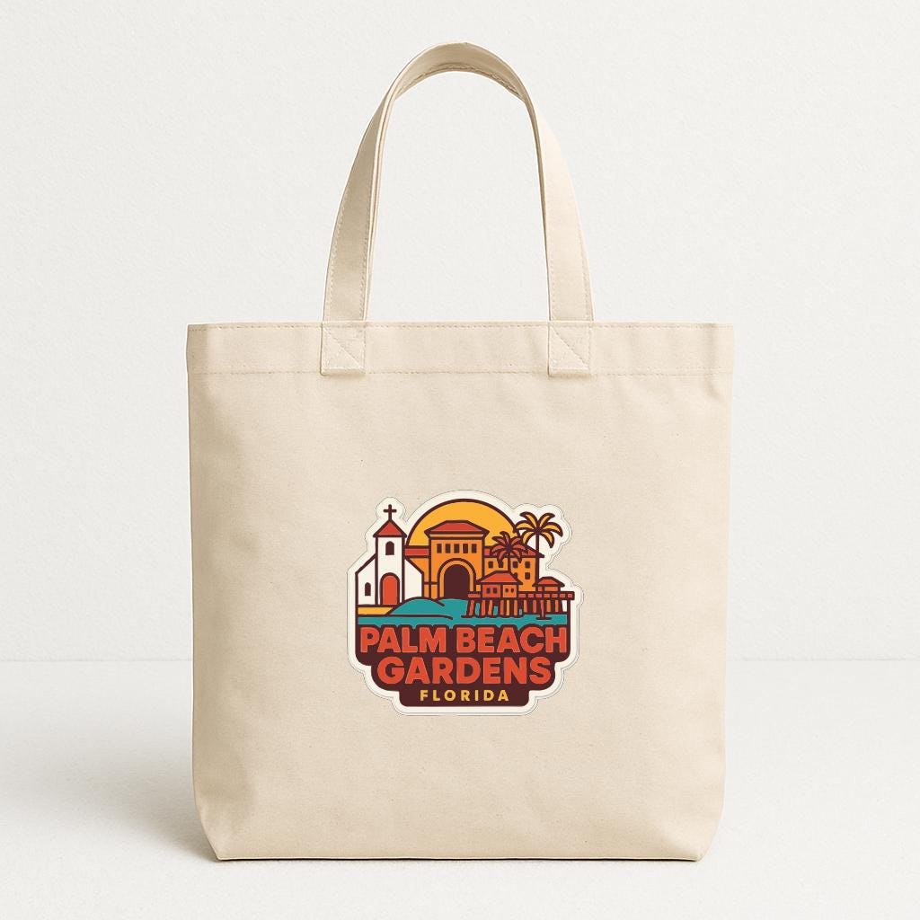 A beige tote bag with a graphic design featuring a tropical beach scene and the text "Palm Beach Gardens, Florida".