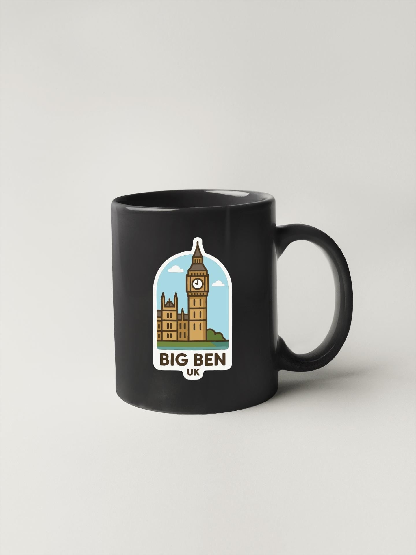 A black coffee mug with a sticker depicting Big Ben and the text "BIG BEN UK" printed on it.