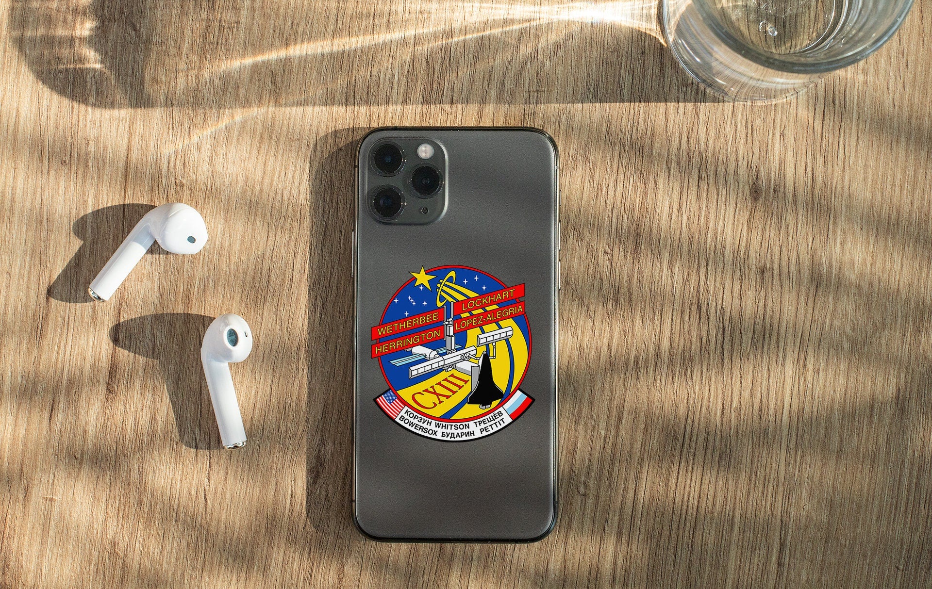 a cell phone sitting on top of a wooden table