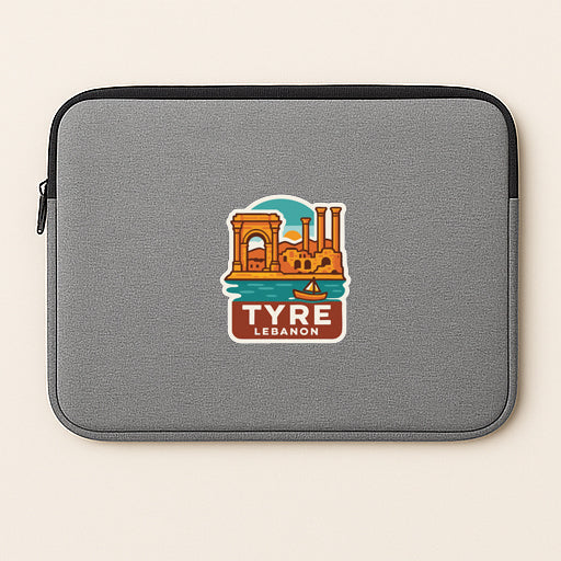 a gray laptop sleeve with a sticker depicting a cityscape and the text "TYRE LEBANON" printed on it.