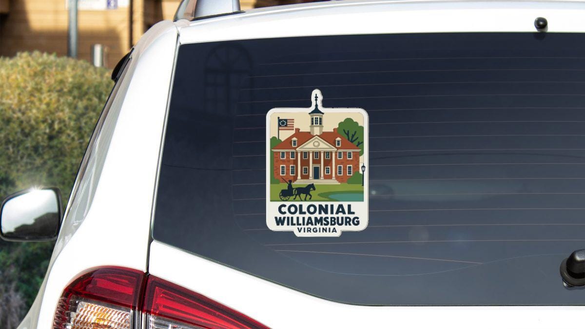 A sticker on the rear window of a white car, depicting a colonial building with a horse and carriage, and the text "COLONIAL WILLIAMSBURG VIRGINIA".