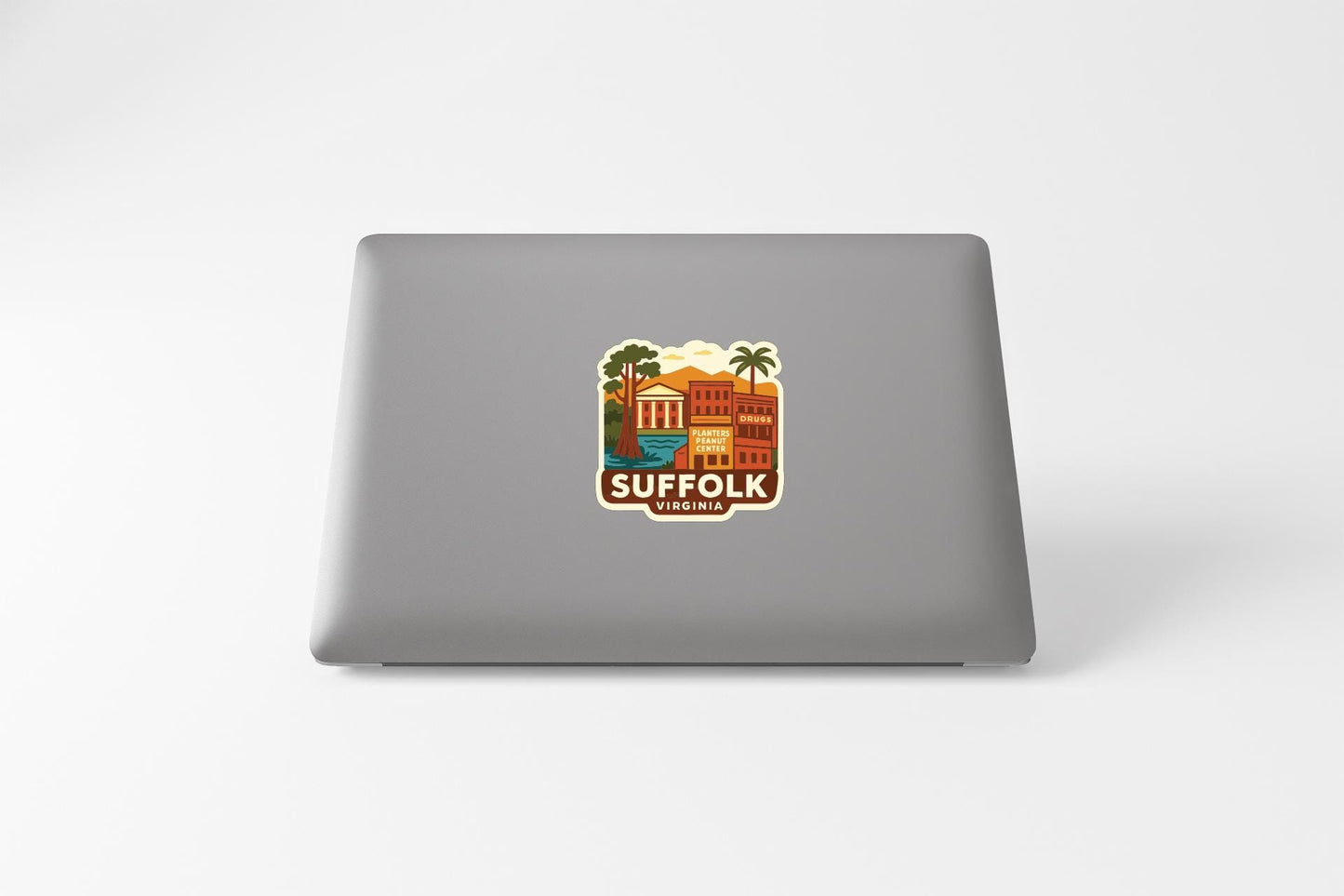 a sticker with a graphic of a building and palm trees, along with the text "SUFFOLK VIRGINIA" printed on it.