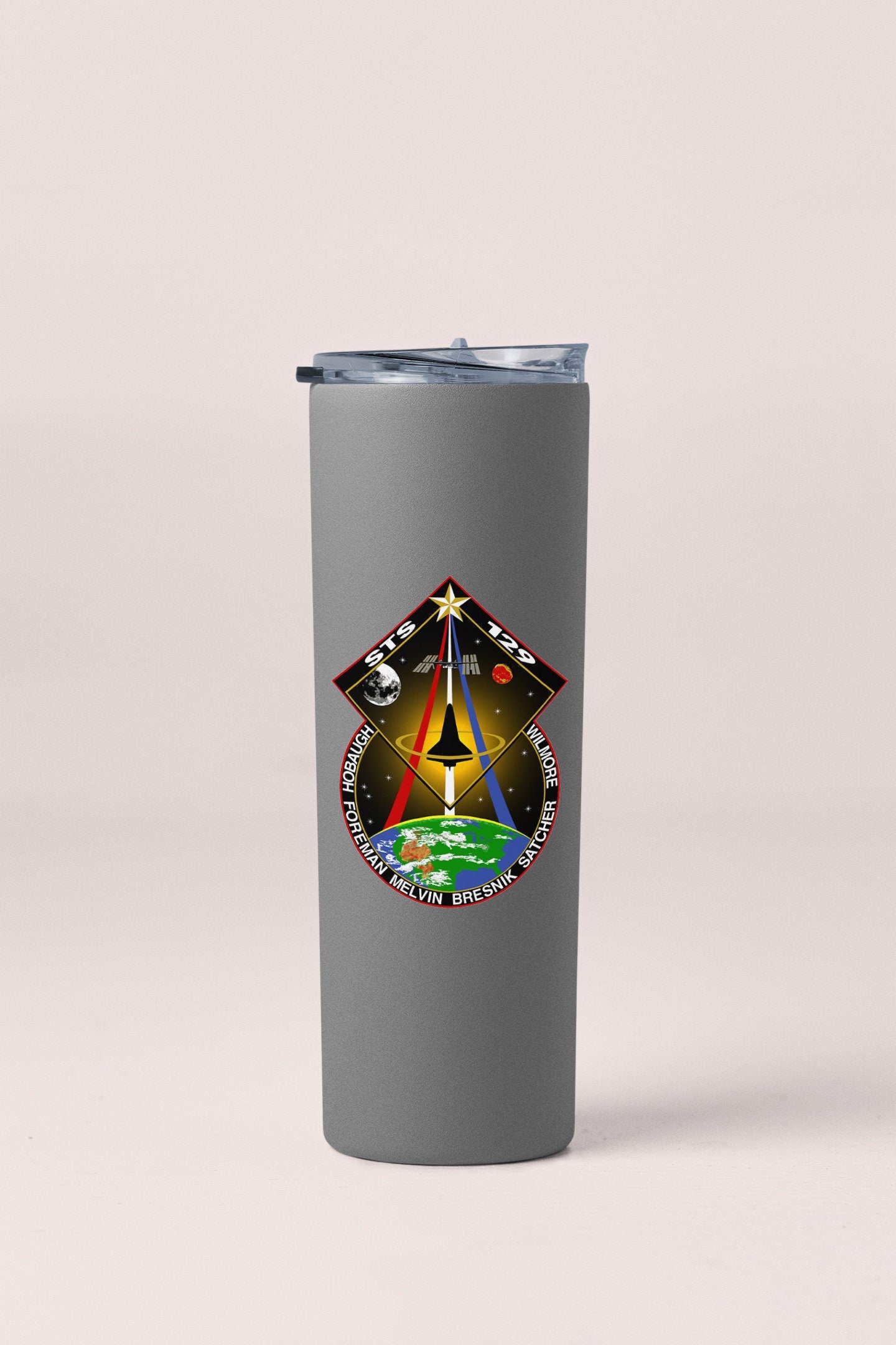 a stainless steel tumbler with a picture of a space shuttle on it