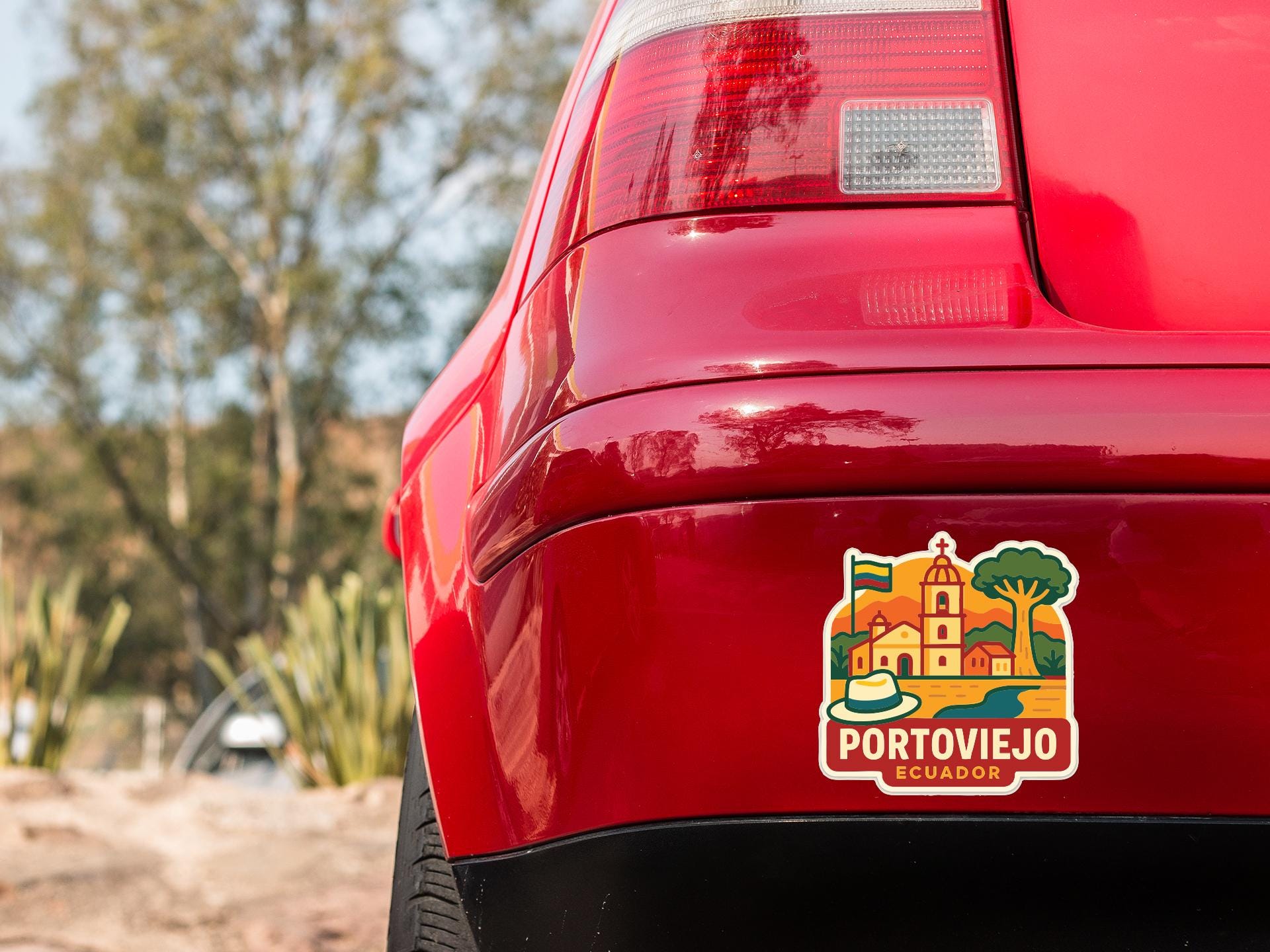 the rear end of a red car with a sticker on the back window that says "PORTOVIEJO ESCUDOR".
