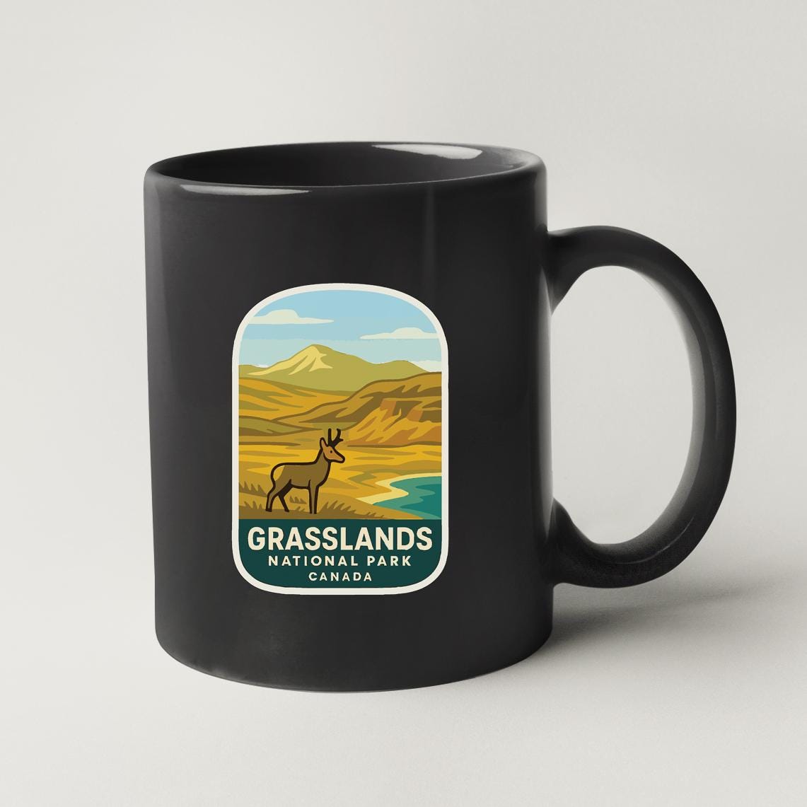 A black coffee mug with a label that says "Grasslands National Park Canada".
