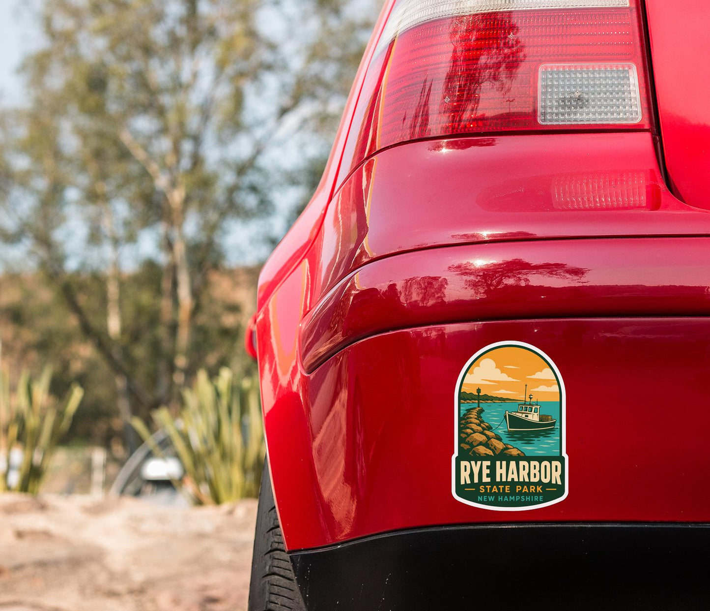 the rear end of a red car with a sticker on the back window that says "RYE HARBOR STATE PARK NEW HAMPTON".