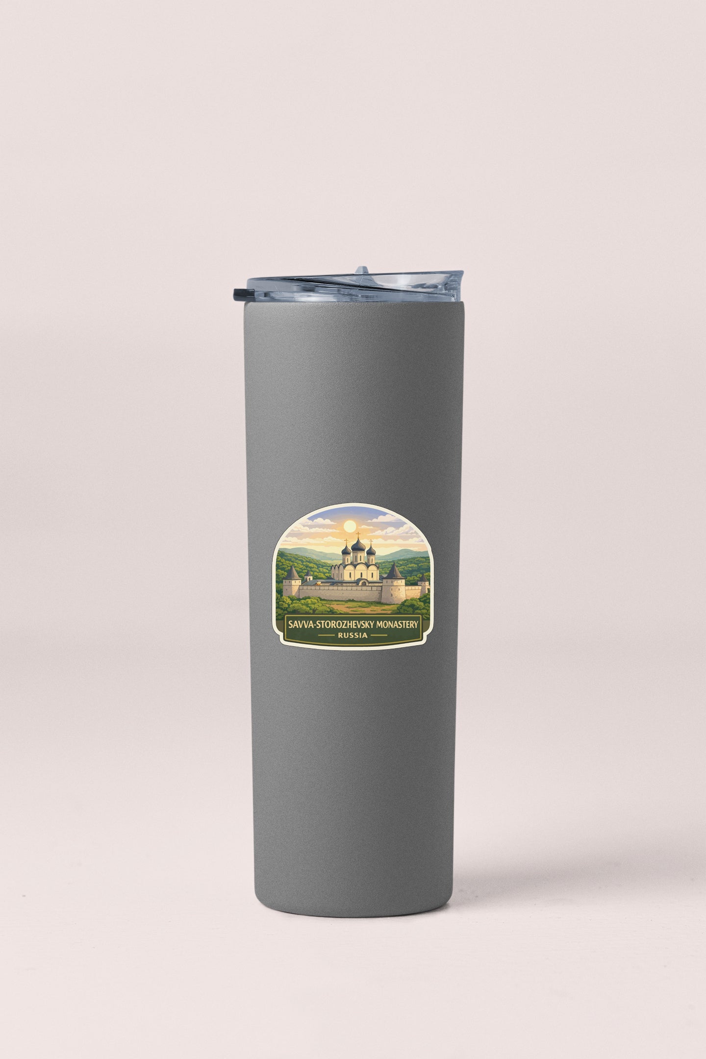 A gray cylindrical container with a lid and a label featuring a castle and a landscape.