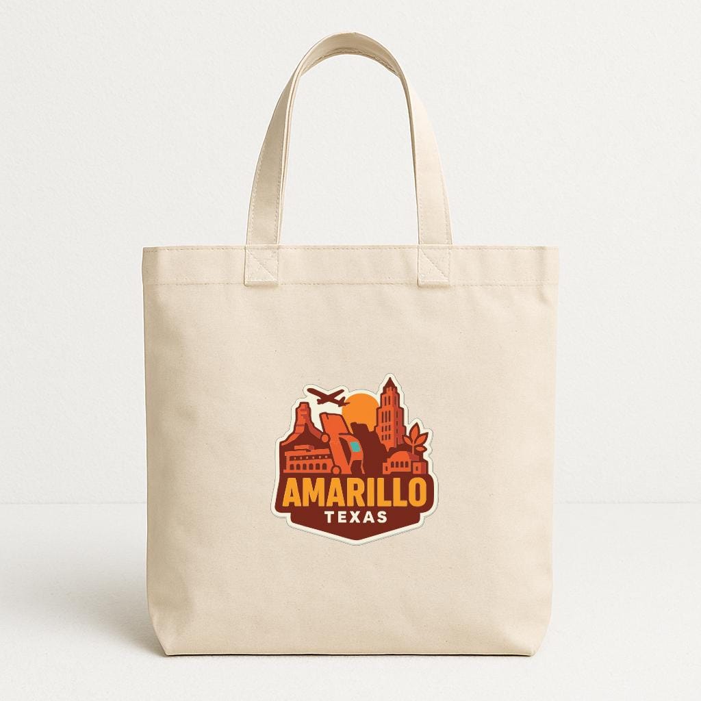 A beige tote bag with a graphic design featuring the text "AMARILLO TEXAS" and an illustration of a city skyline.