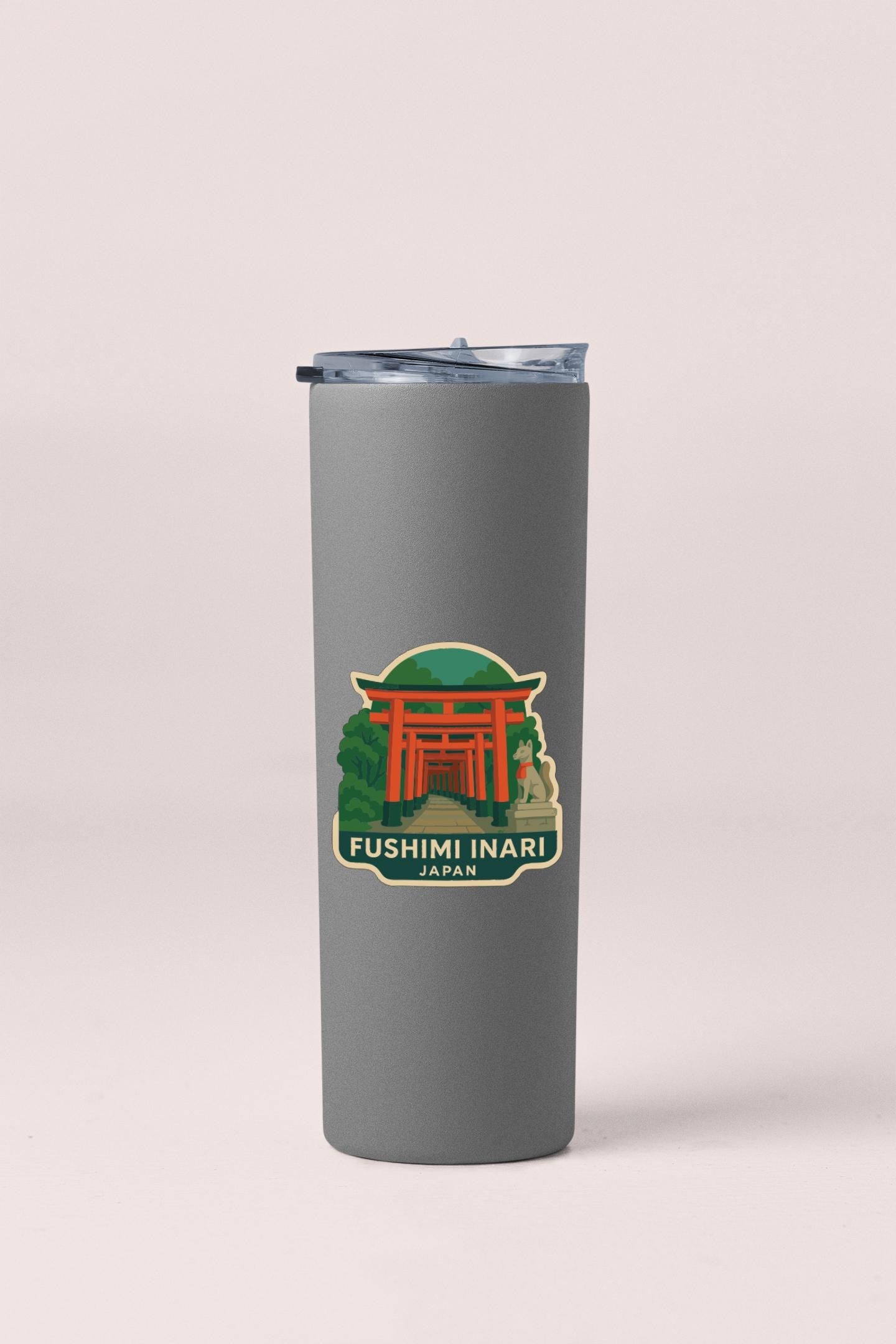 A gray insulated tumbler with a sticker depicting the Fushimi Inari temple in Japan.
