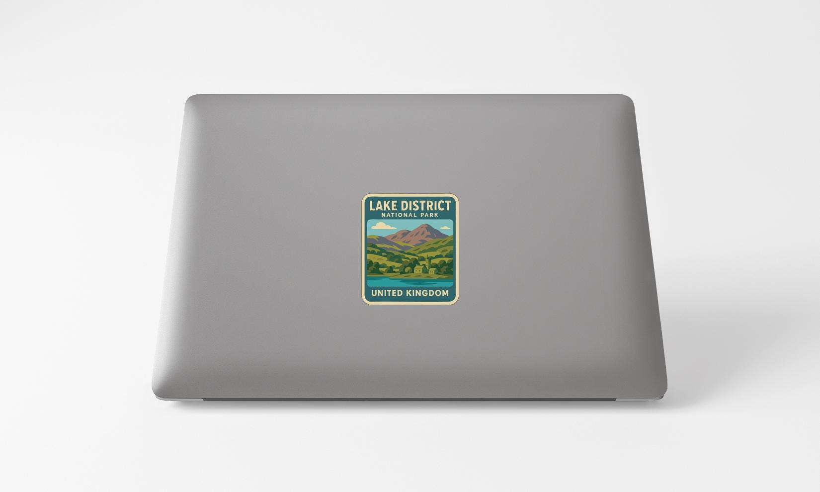 a sticker on the back of a laptop that says "LAKED DISTRICT UNITED KINGDOM".