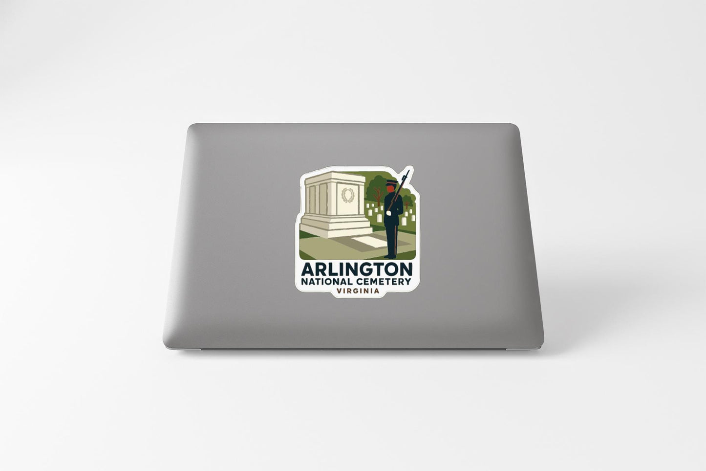 a sticker on a laptop that displays an illustration of a monument and a person, along with the text "ARLINGTON NATIONAL CEMERY VIRGINIA".