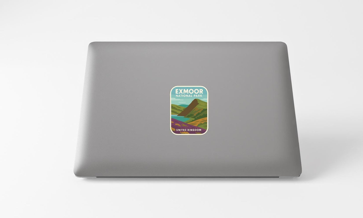 a sticker with a mountain landscape on a laptop.