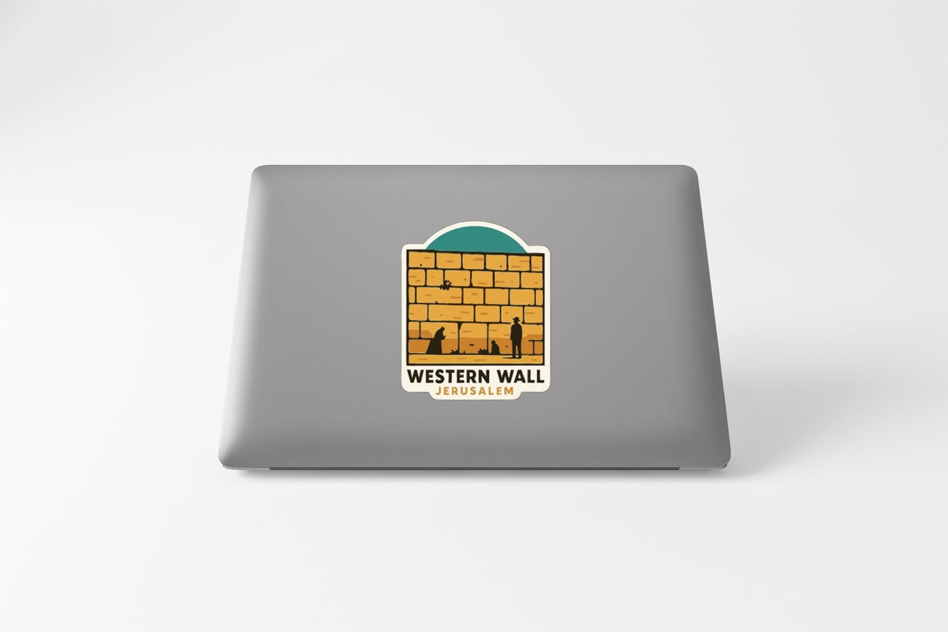 A sticker on the back of a laptop, depicting a graphic of the Western Wall in Jerusalem.