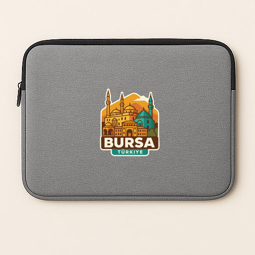 A gray laptop sleeve with a sticker depicting the skyline of Istanbul, Turkey.