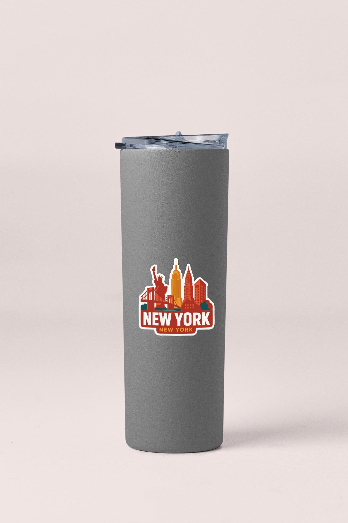 A gray tumbler with a printed logo of New York City's skyline.