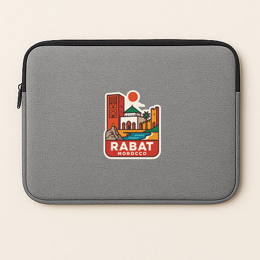 a gray laptop sleeve with a colorful sticker depicting Rabat, Morocco.