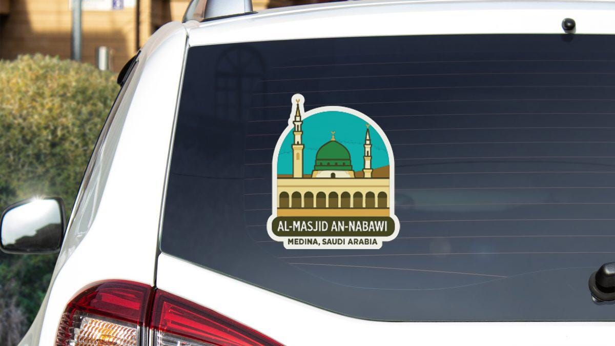 A sticker on the rear window of a car, depicting the Al-Ma'mid Mosque in Medina, Saudi Arabia.