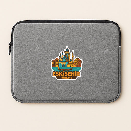 A gray laptop sleeve with a sticker of a city skyline and the text "Eskisehir, Turkey" printed on it.