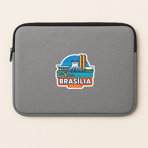 A gray laptop sleeve with a colorful sticker depicting the city of Brasilia, Brazil.