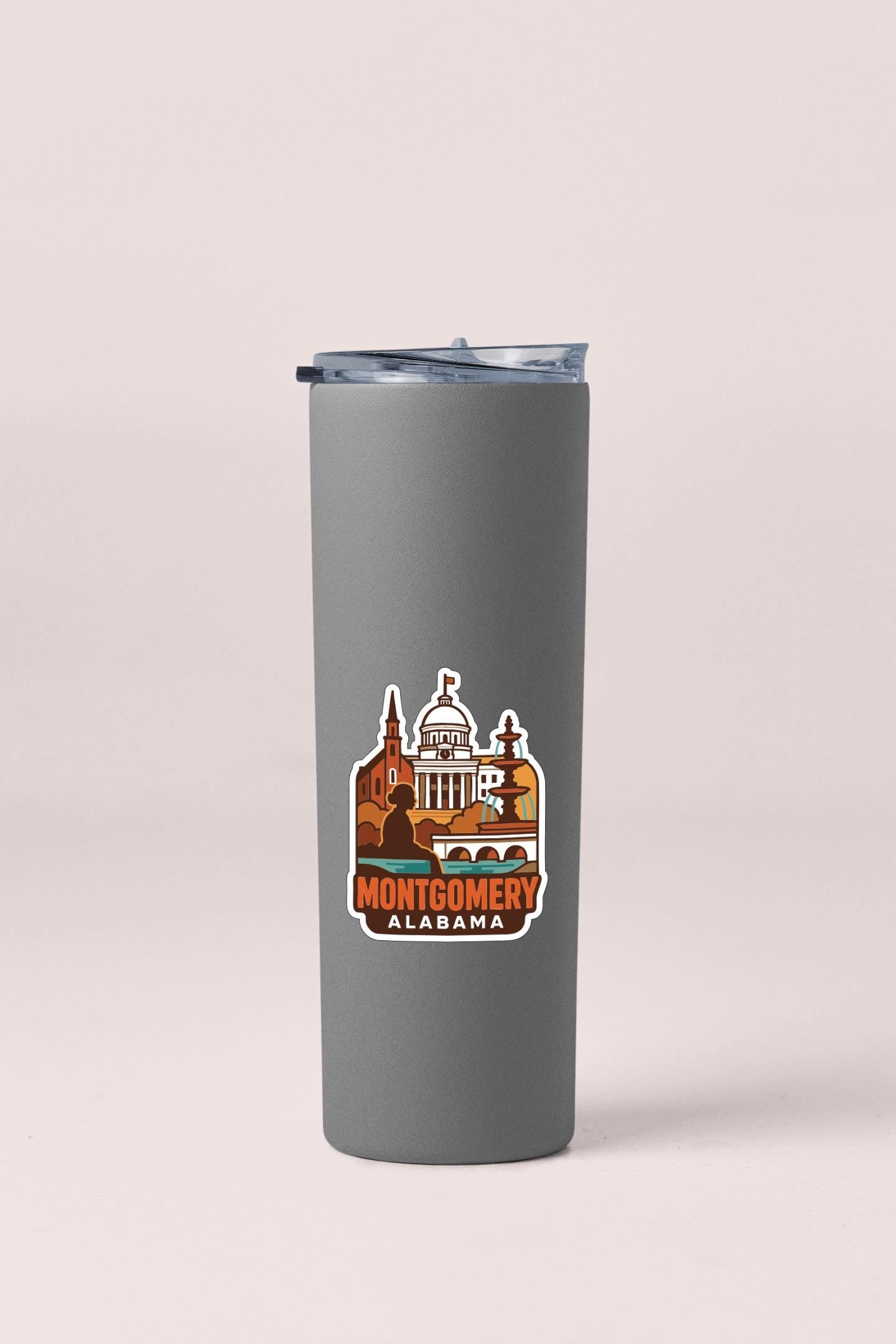 A gray insulated tumbler with a sticker depicting the state of Alabama.