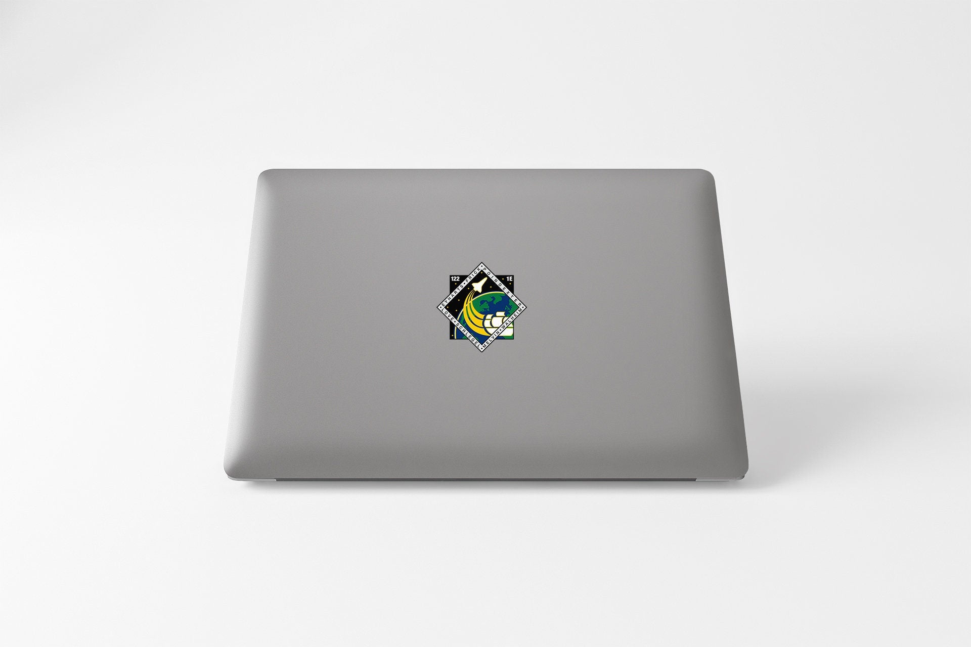 a laptop with a sticker of a cat on it