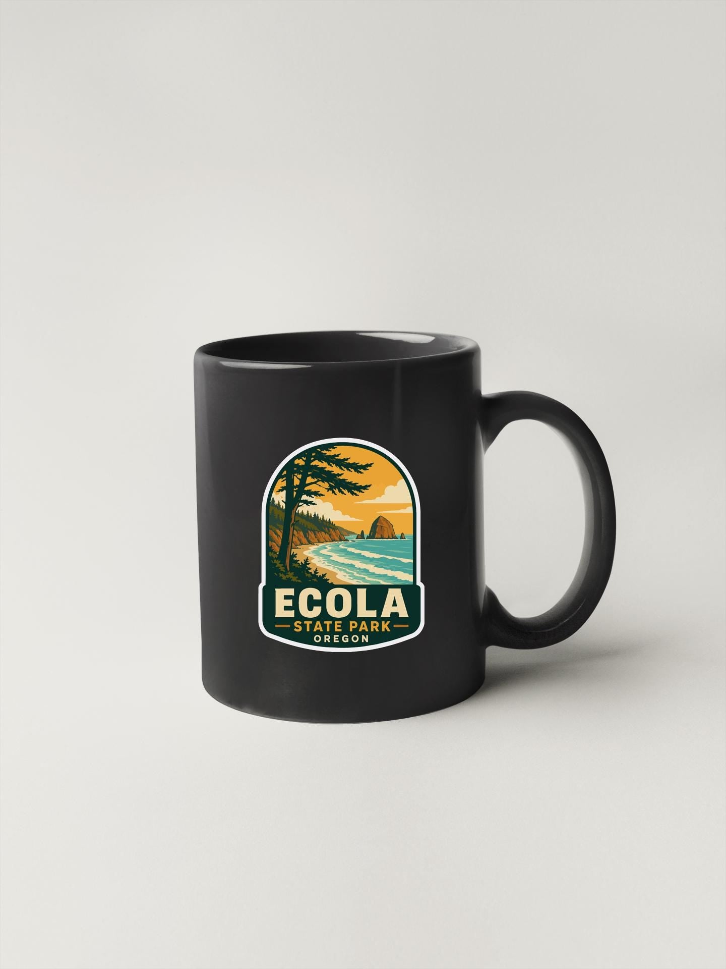 A black coffee mug with a graphic design depicting a scenic landscape, including a beach, mountains, and a sunset.